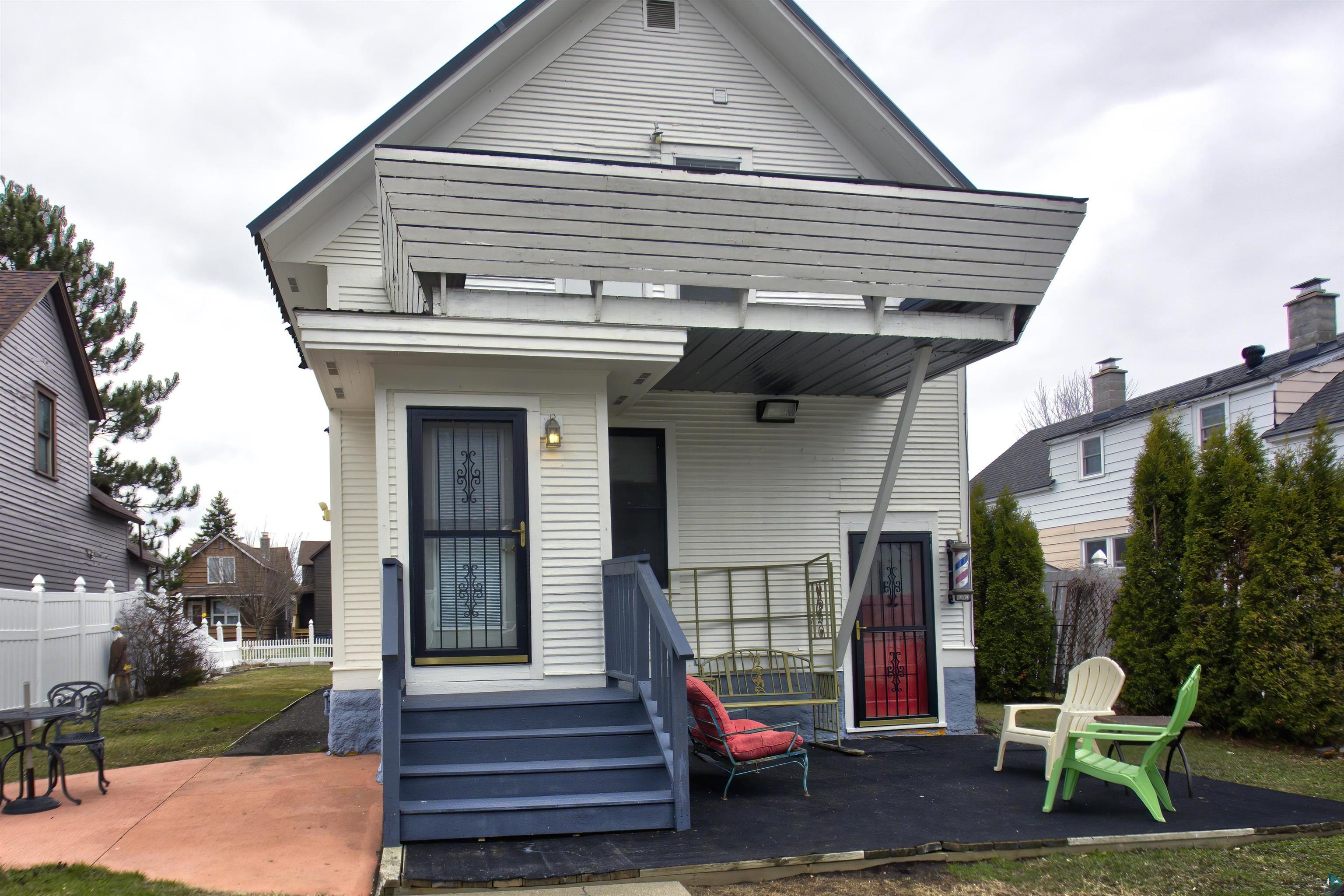 24 East Conan Street Ely, MN 55731 - Photo 2 of 27 White horizontal siding exterior with a pitched roofline