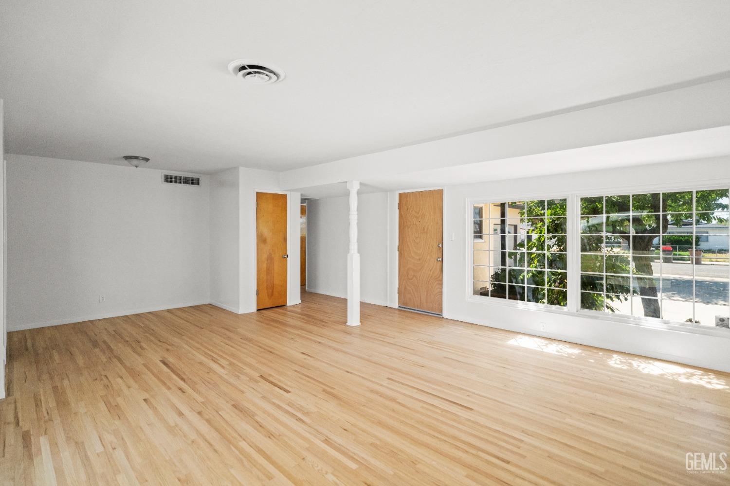 Undisclosed Address Bakersfield, CA 93304 - Photo 11 of 41 a view of an empty room with wooden floor and a window