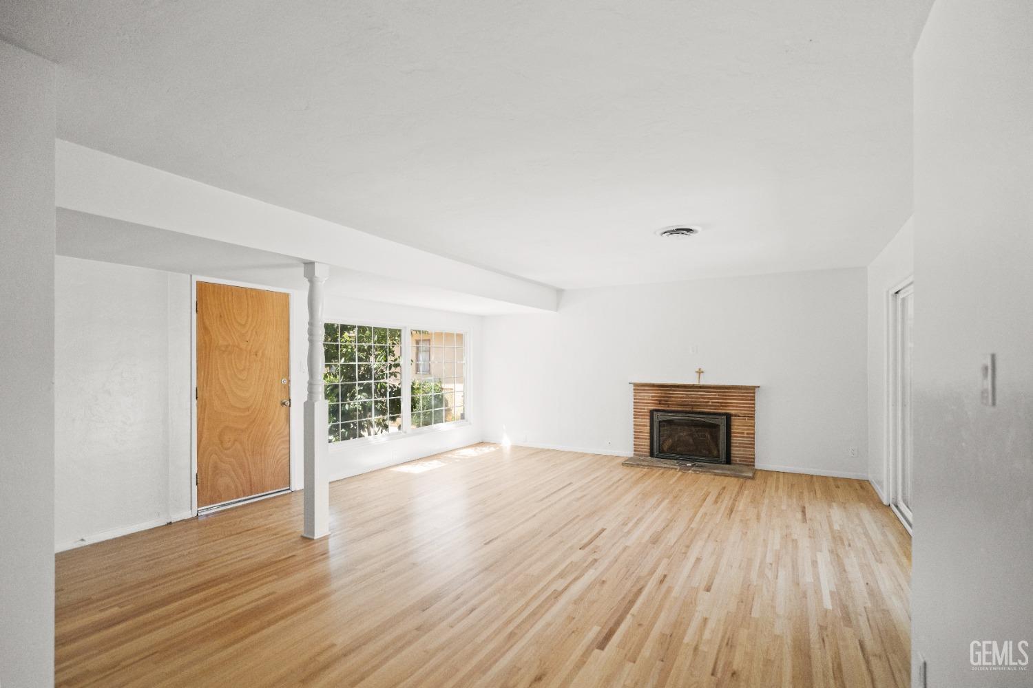 Undisclosed Address Bakersfield, CA 93304 - Photo 12 of 41 wooden floor in an empty room with a window