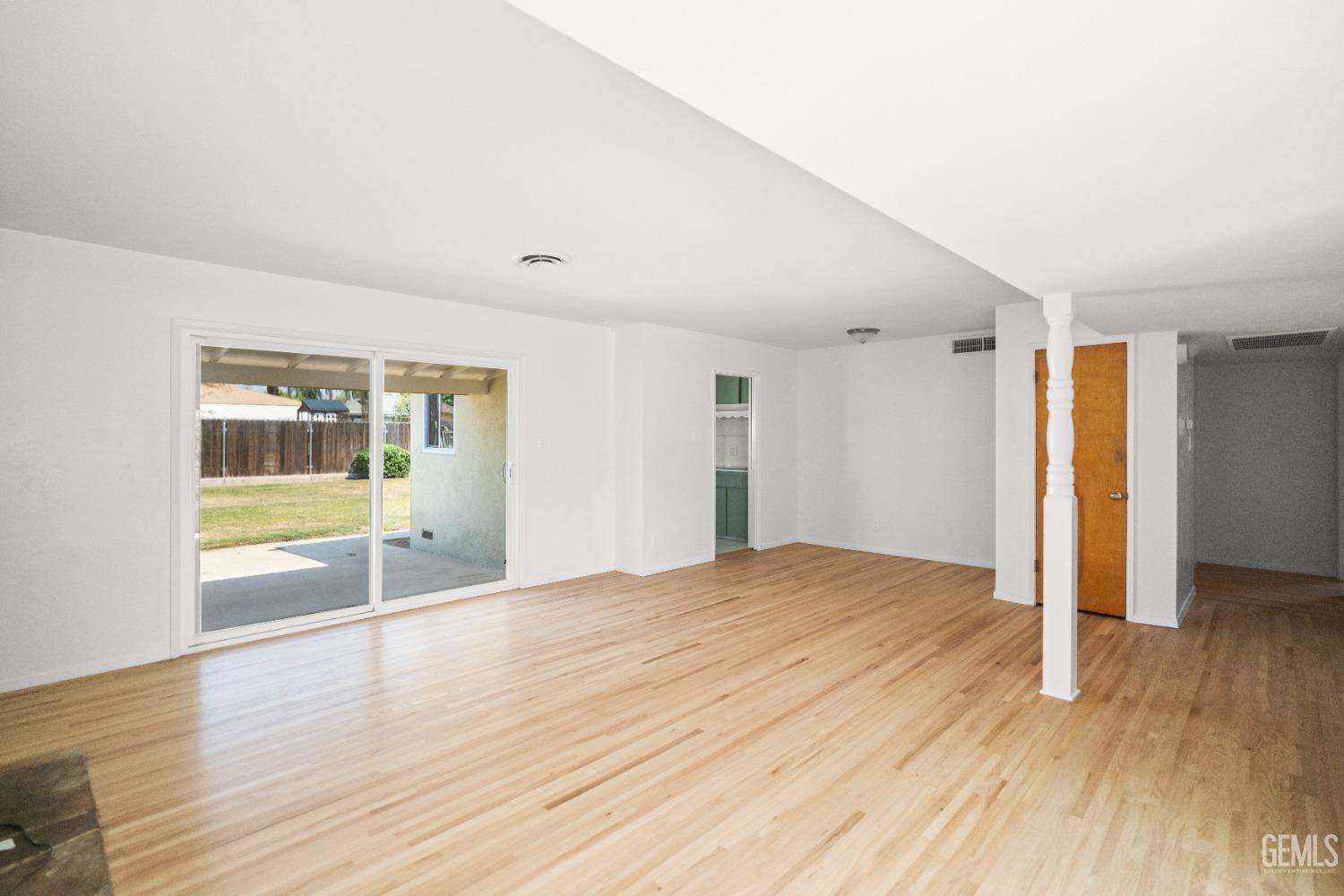 Undisclosed Address Bakersfield, CA 93304 - Photo 14 of 41 a view of an empty room with wooden floor and a window