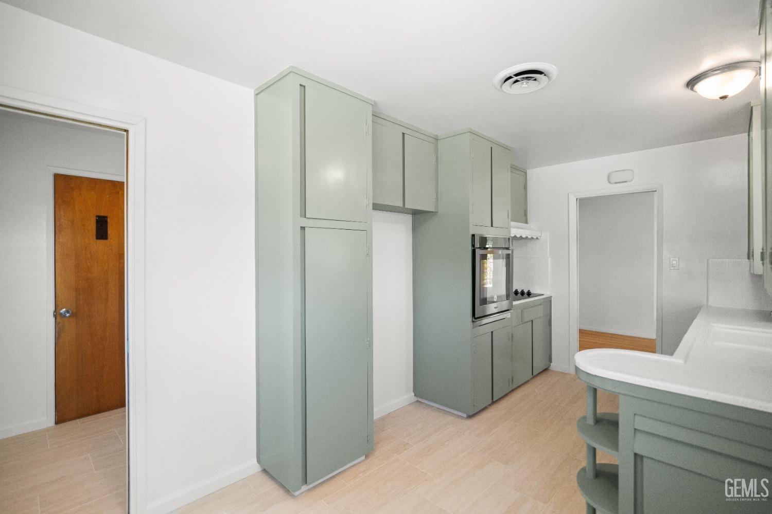 Undisclosed Address Bakersfield, CA 93304 - Photo 24 of 41 a kitchen with cabinets and stainless steel appliances