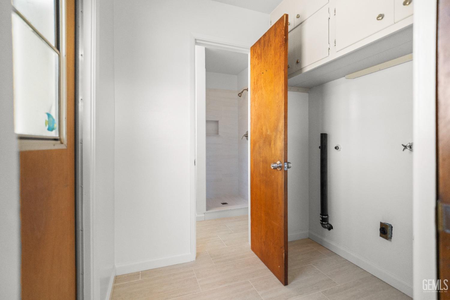 Undisclosed Address Bakersfield, CA 93304 - Photo 26 of 41 a view of a bathroom with a door