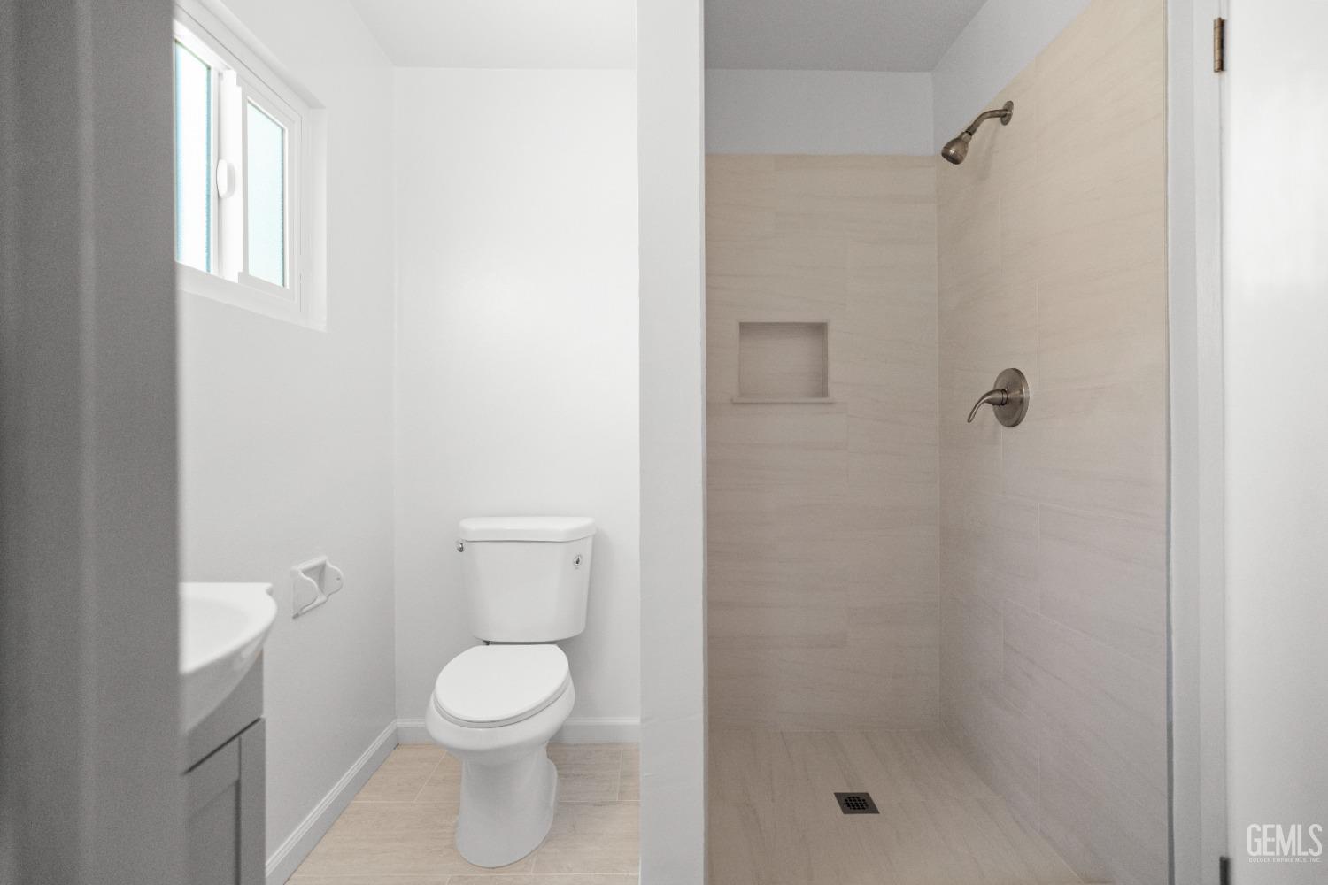 Undisclosed Address Bakersfield, CA 93304 - Photo 28 of 41 a bathroom with a toilet a sink and shower