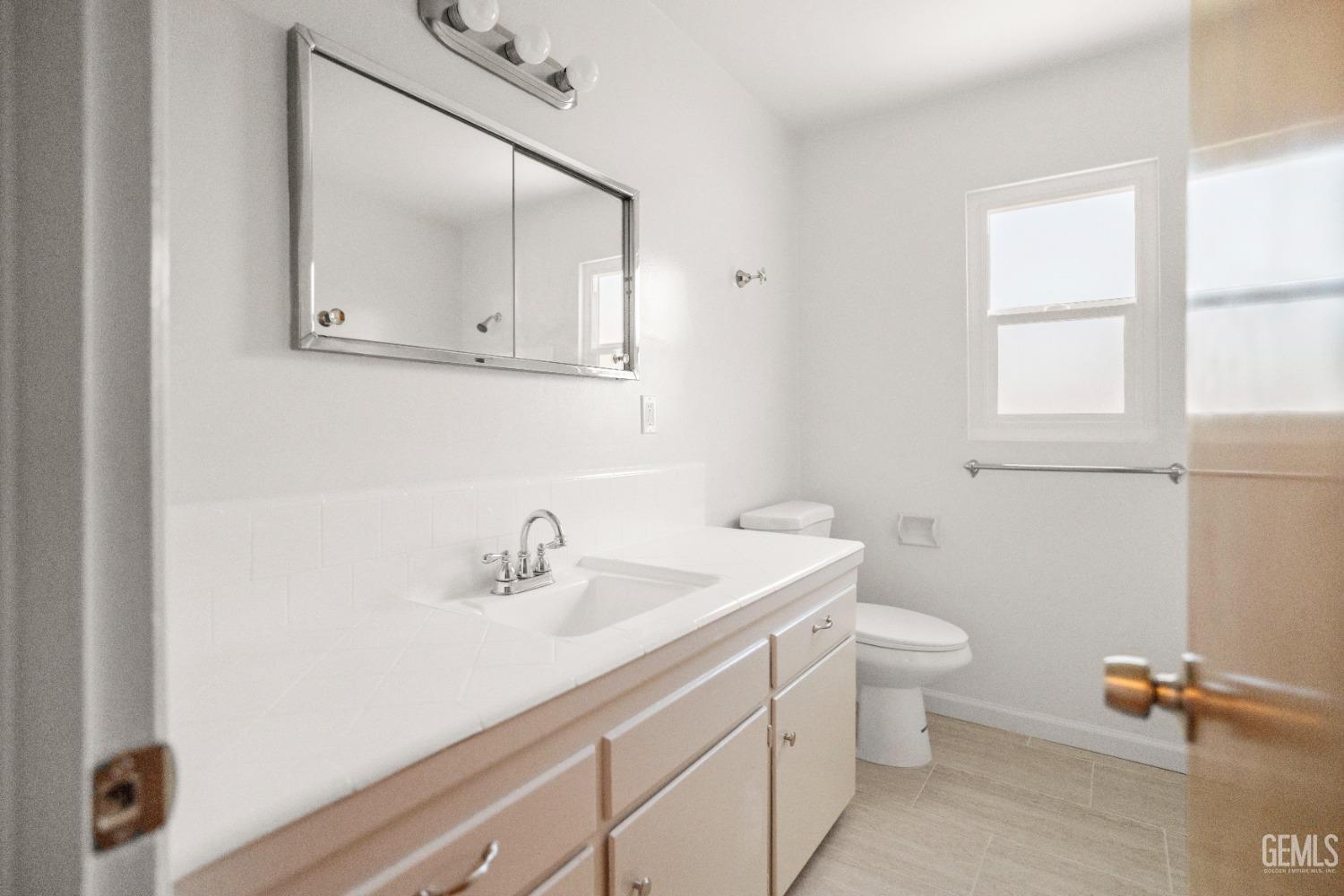 Undisclosed Address Bakersfield, CA 93304 - Photo 32 of 41 a bathroom with a sink a toilet and mirror