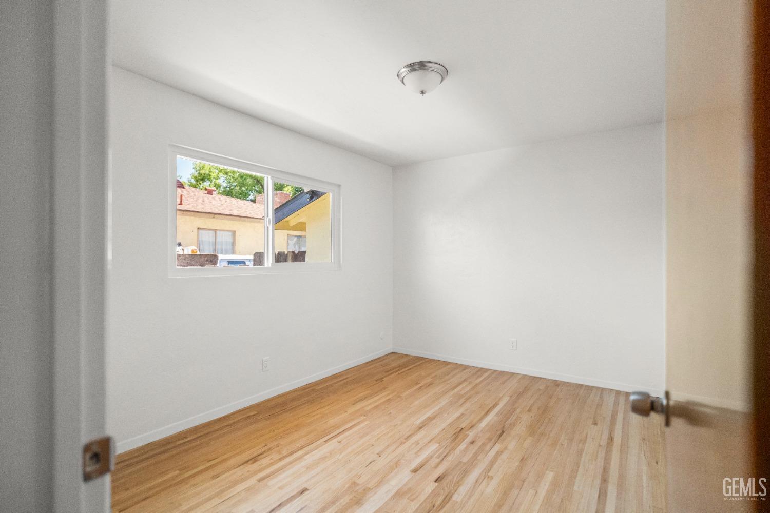Undisclosed Address Bakersfield, CA 93304 - Photo 34 of 41 a view of a room that has a window and wooden floor