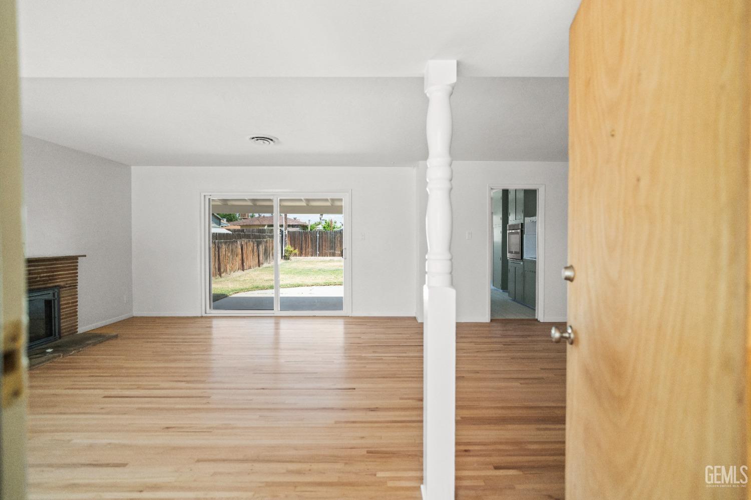 Undisclosed Address Bakersfield, CA 93304 - Photo 8 of 41 a view of an empty room with window and hardwood floor