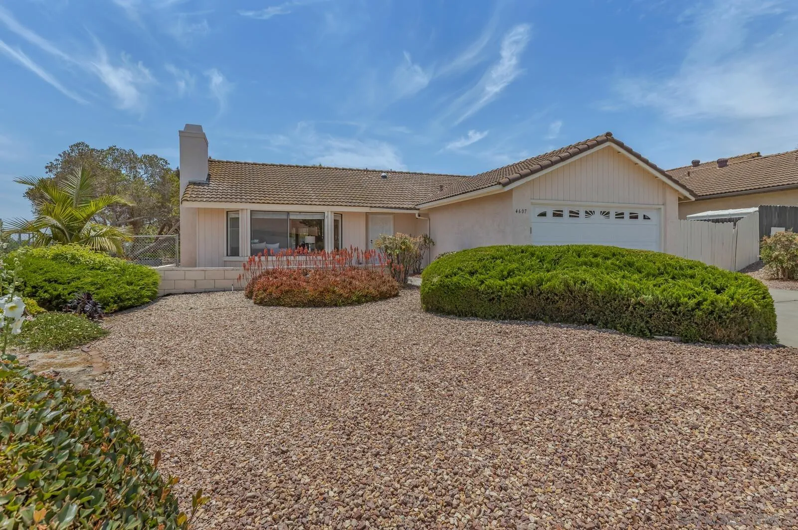 4607 Briar Ridge Road Oceanside, CA 92056 - Photo 1 of 32 a front view of a house with garden