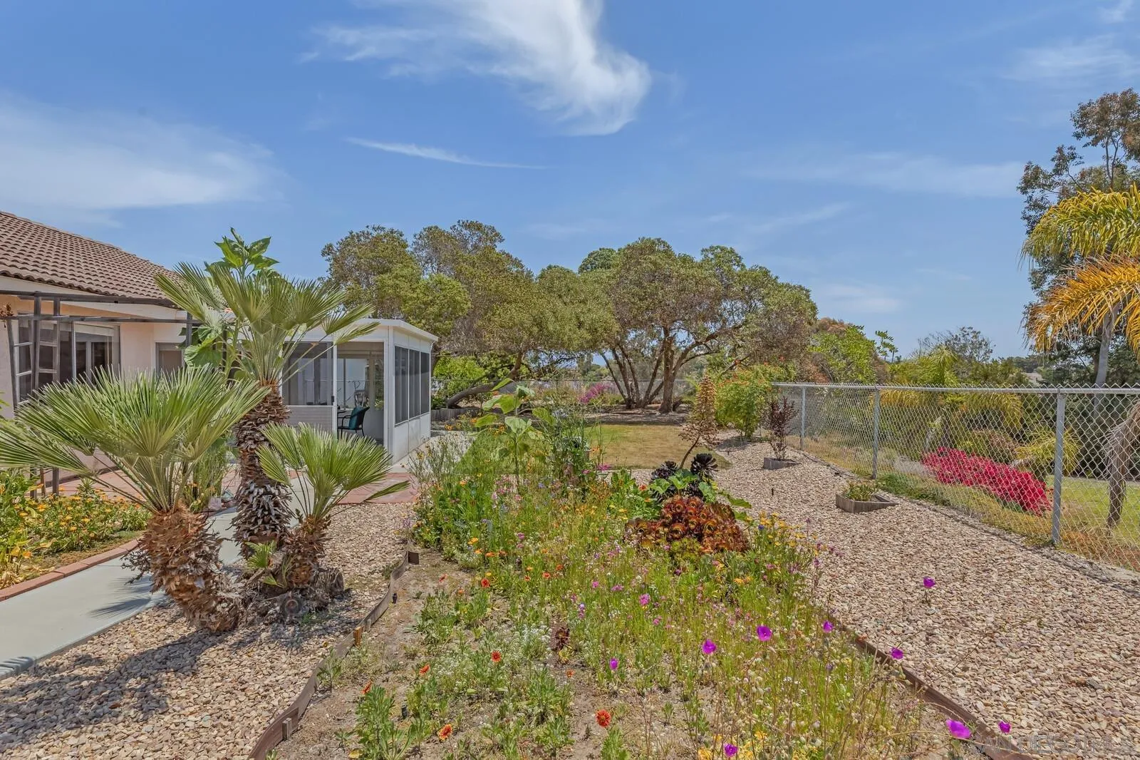 4607 Briar Ridge Road Oceanside, CA 92056 - Photo 27 of 32 a view of a garden with a building in the background