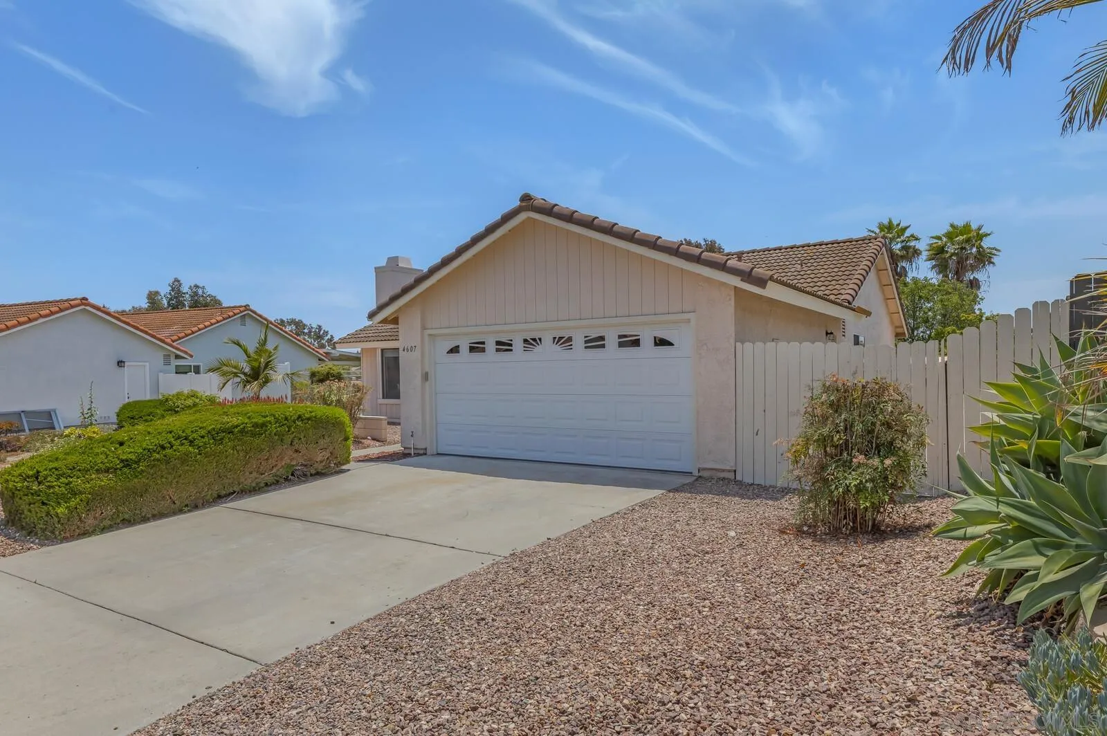 4607 Briar Ridge Road Oceanside, CA 92056 - Photo 3 of 32 a front view of a house with a yard and garage
