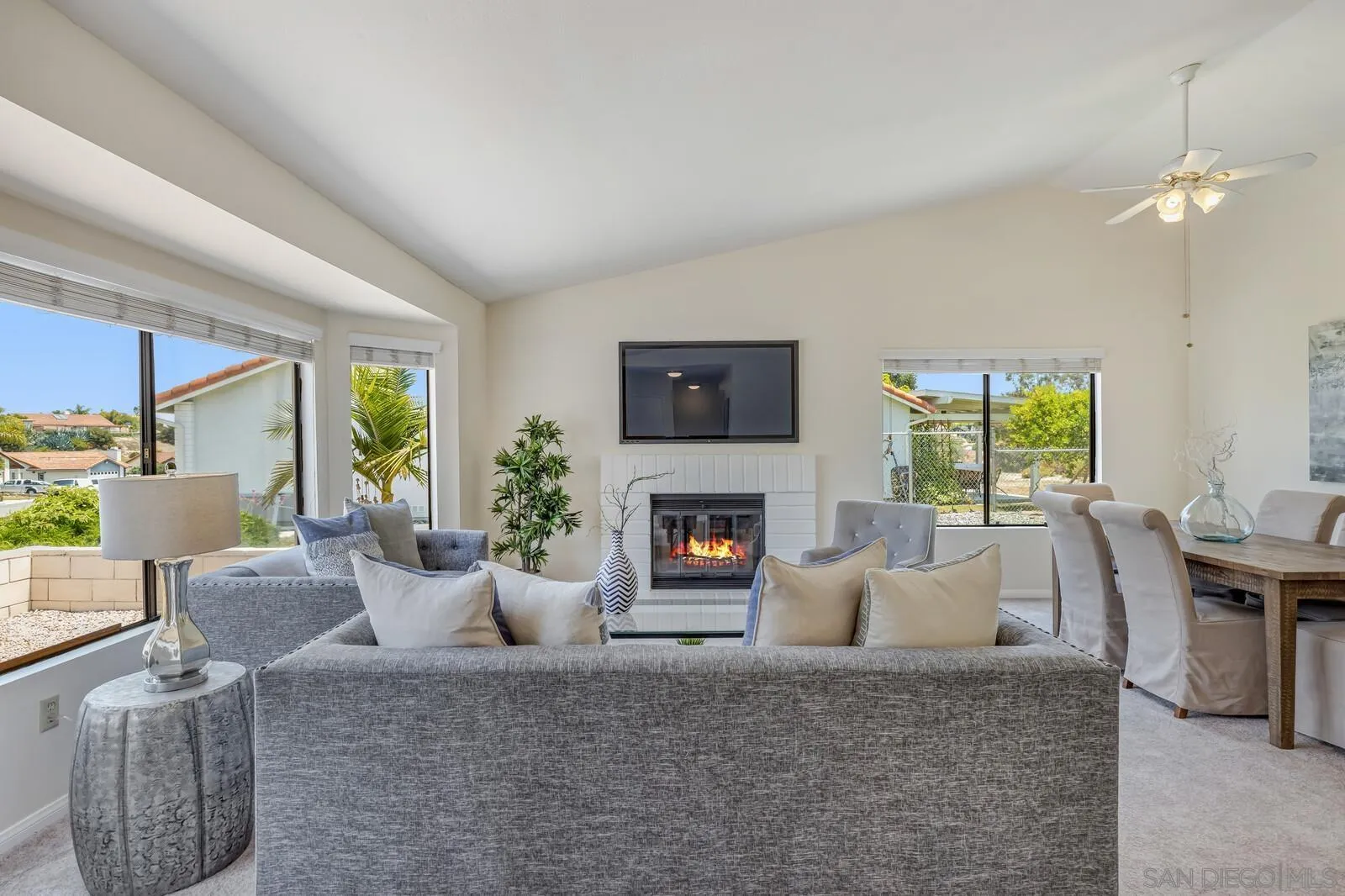 4607 Briar Ridge Road Oceanside, CA 92056 - Photo 4 of 32 a living room with furniture a fireplace and a flat screen tv