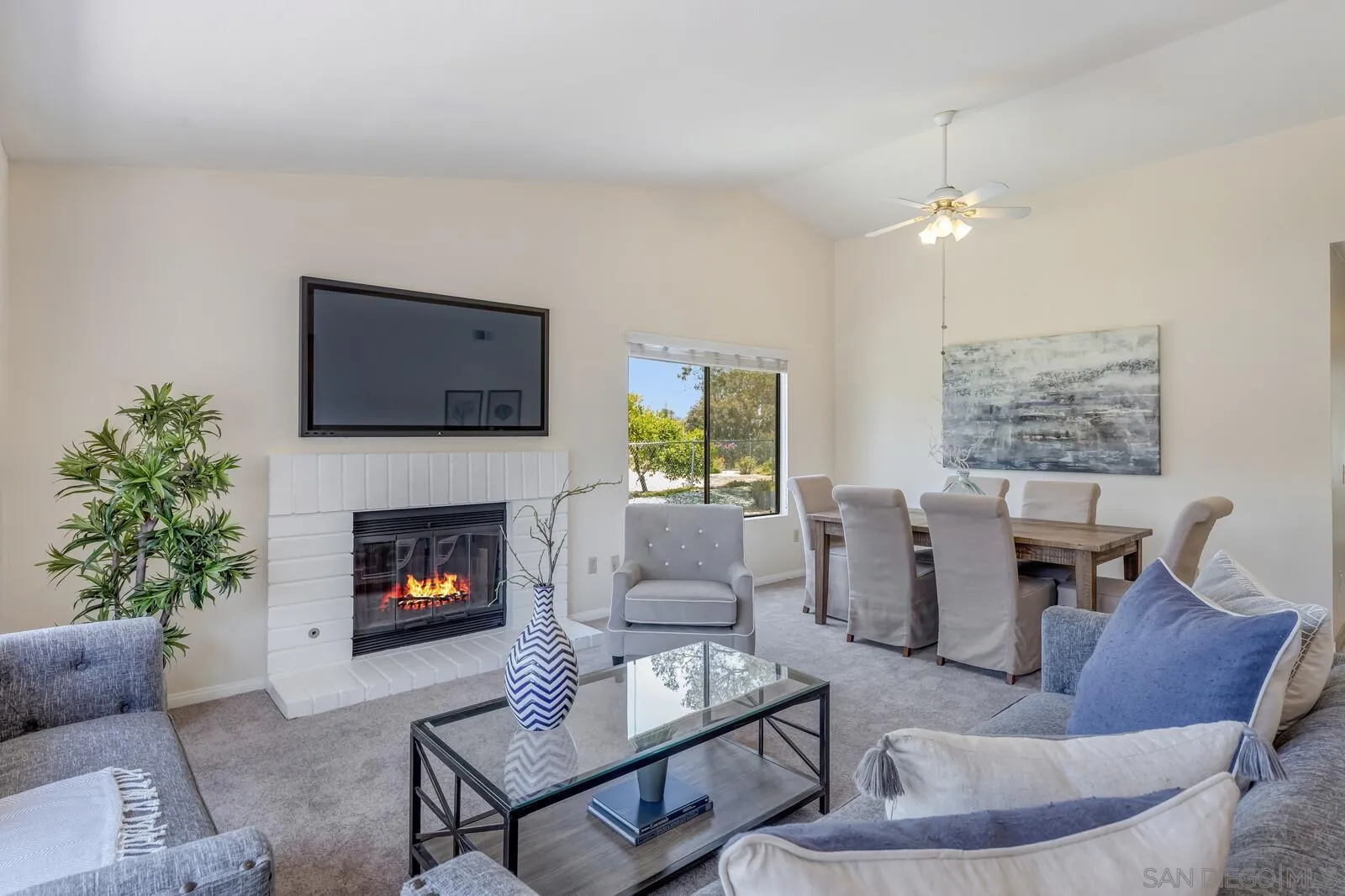 4607 Briar Ridge Road Oceanside, CA 92056 - Photo 5 of 32 a living room with furniture a fireplace and a flat screen tv