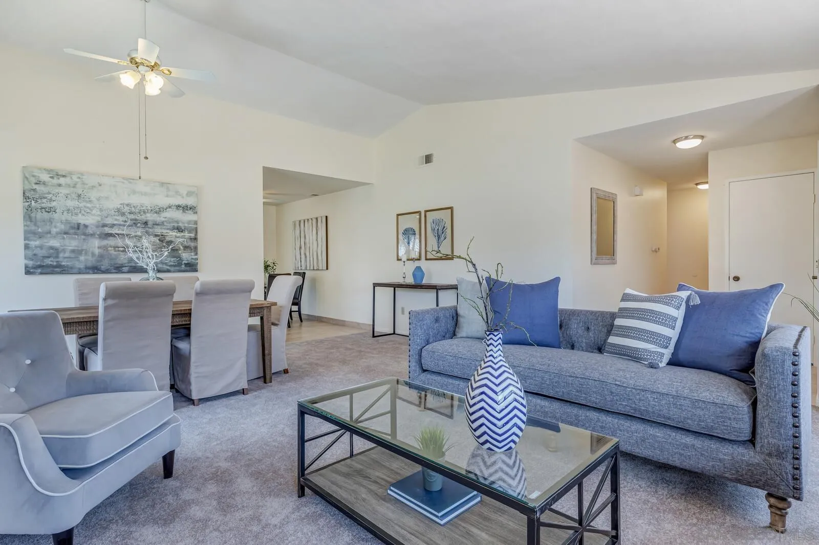 4607 Briar Ridge Road Oceanside, CA 92056 - Photo 7 of 32 a living room with furniture and a chandelier