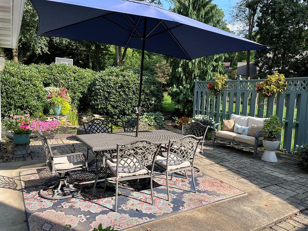 80 Aaron Lane Indiana, PA 15701 - Photo 21 of 25 a patio with tables and chairs under an umbrella