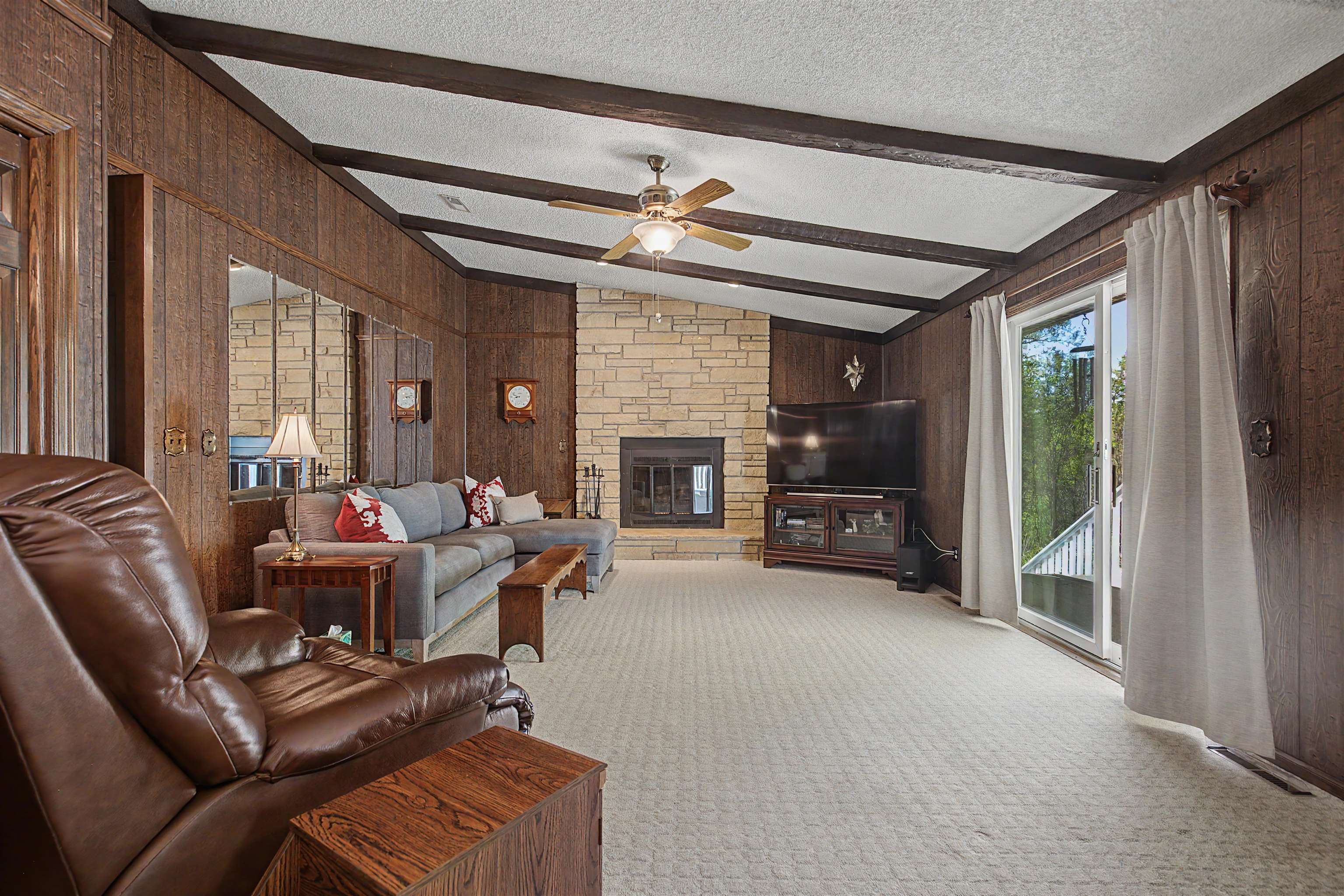 17380 Corbett Road Mount Carroll, IL 61053 - Photo 11 of 65 a living room with furniture a fireplace and a flat tv screen