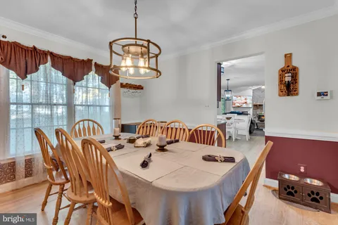 a view of a dining room with furniture and chandelier