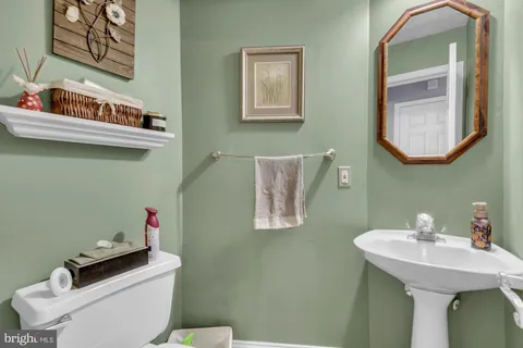 a bathroom with a sink a mirror and a toilet