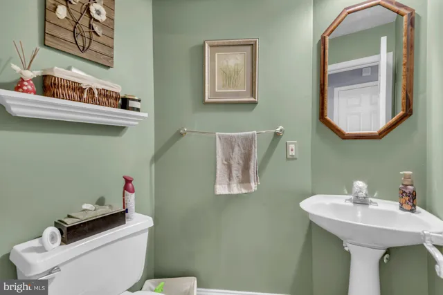 a bathroom with a sink a mirror and a toilet