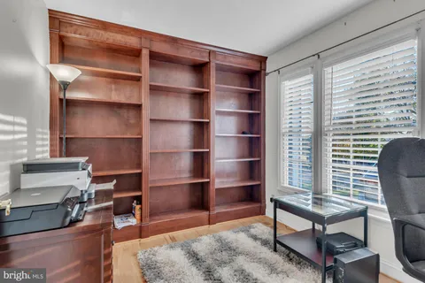 a view of a workspace with furniture and a window