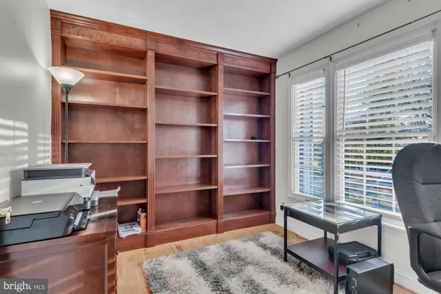 a view of a workspace with furniture and a window