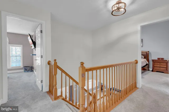 a view of a hallway with windows and stairs