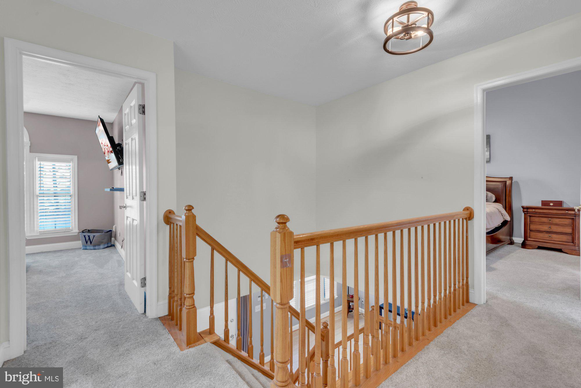 604 Academy Avenue Owings Mills, MD 21117 - Photo 19 of 51 a view of a hallway with windows and stairs