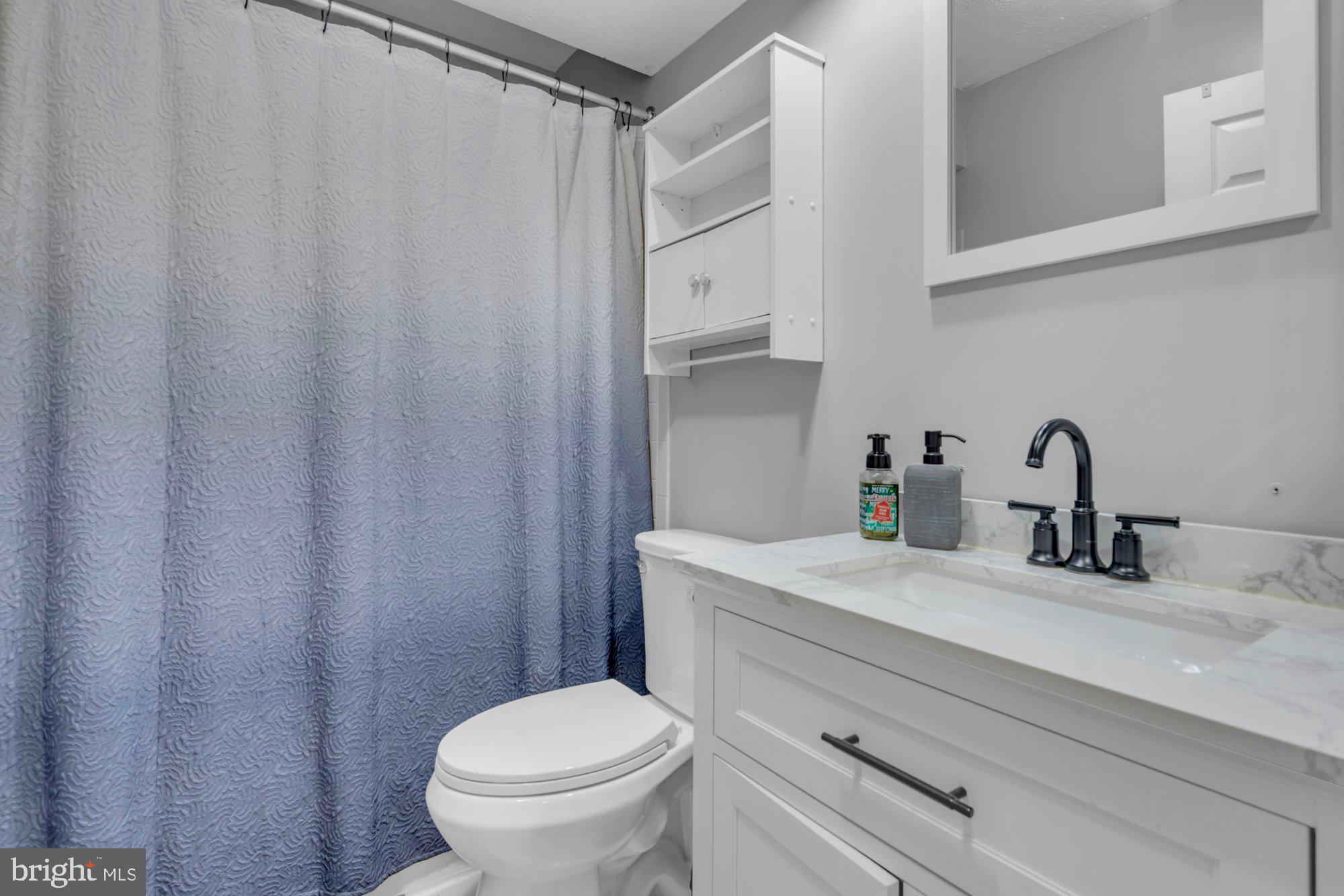 604 Academy Avenue Owings Mills, MD 21117 - Photo 26 of 51 a bathroom with a sink a toilet and a mirror