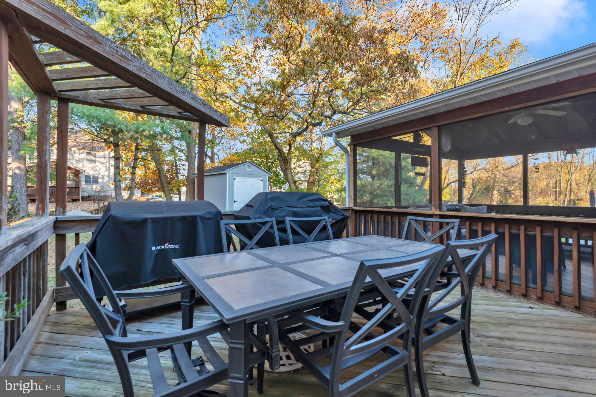 604 Academy Avenue Owings Mills, MD 21117 - Photo 41 of 51 a view of a patio with table and chairs under an umbrella with wooden floor