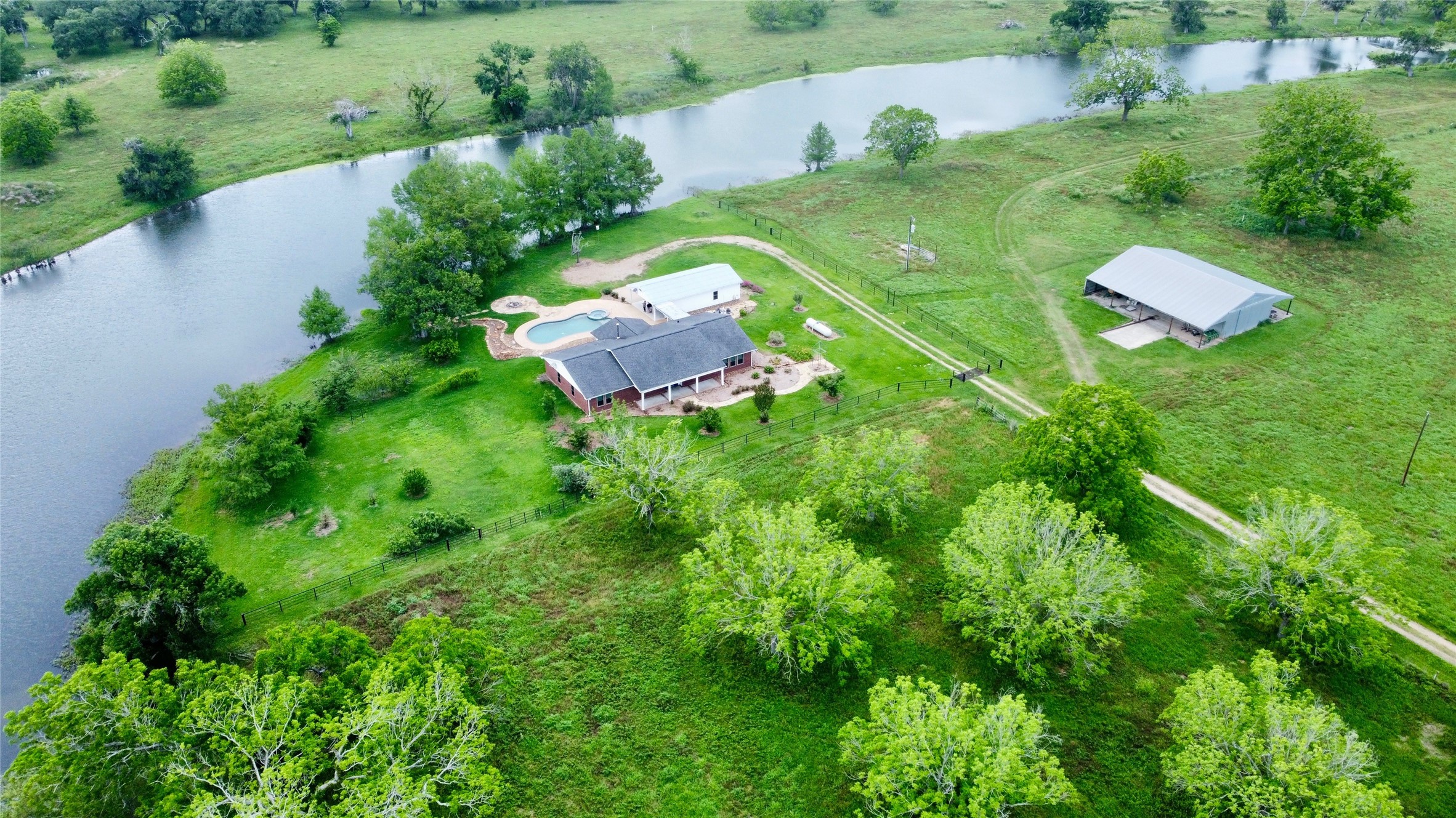 an aerial view of a house with pool