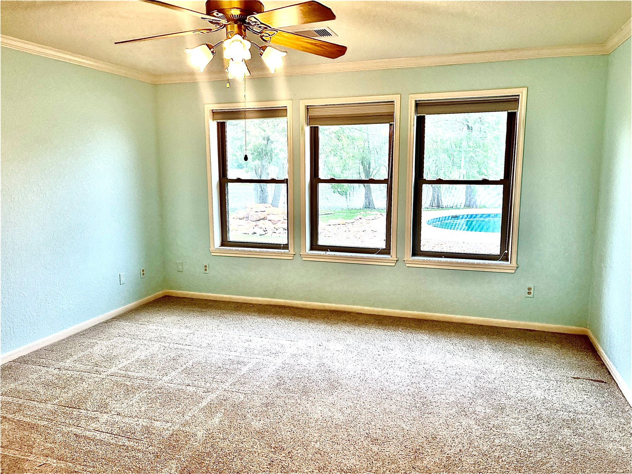 37243 FM 521 Road Bay City, TX 77414 - Photo 15 of 50 an empty room with a window and a fan