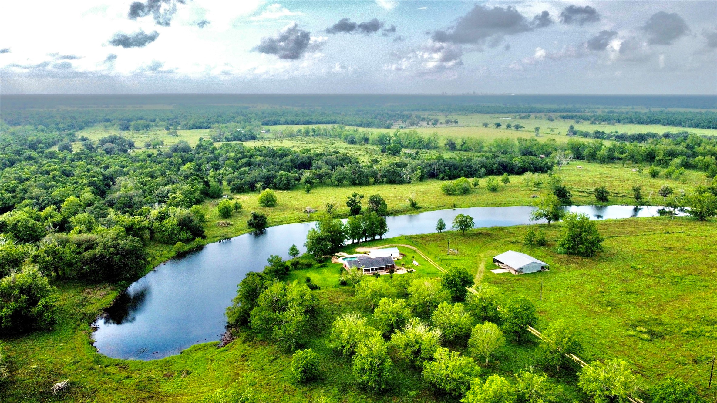 37243 FM 521 Road Bay City, TX 77414 - Photo 2 of 50 a view of a lake with houses in back