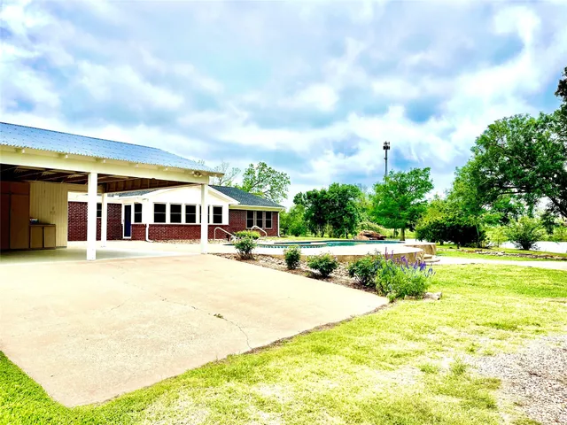 a view of a park with large trees and a big yard
