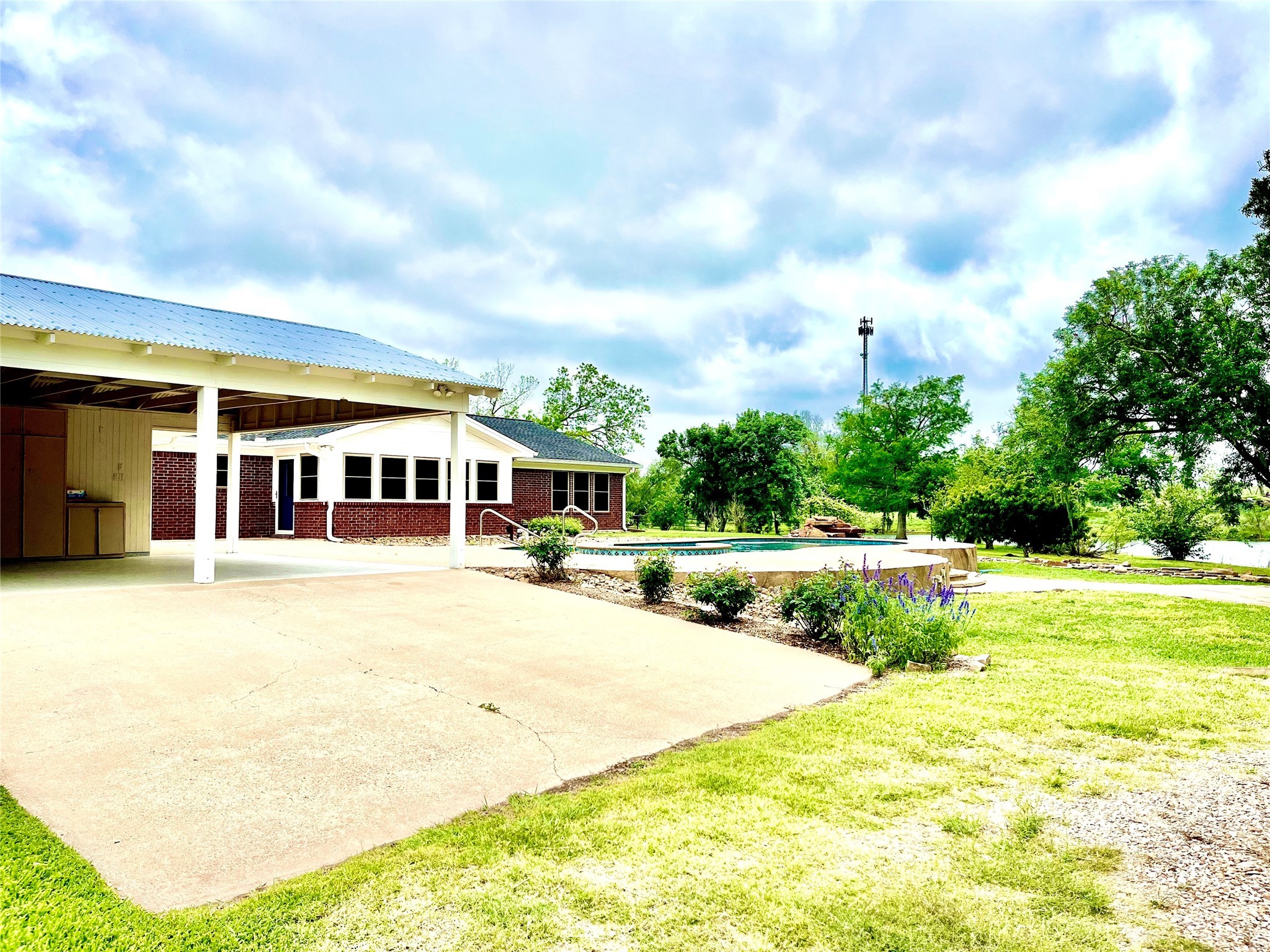 37243 FM 521 Road Bay City, TX 77414 - Photo 30 of 50 a view of swimming pool with seating area and trees in the background