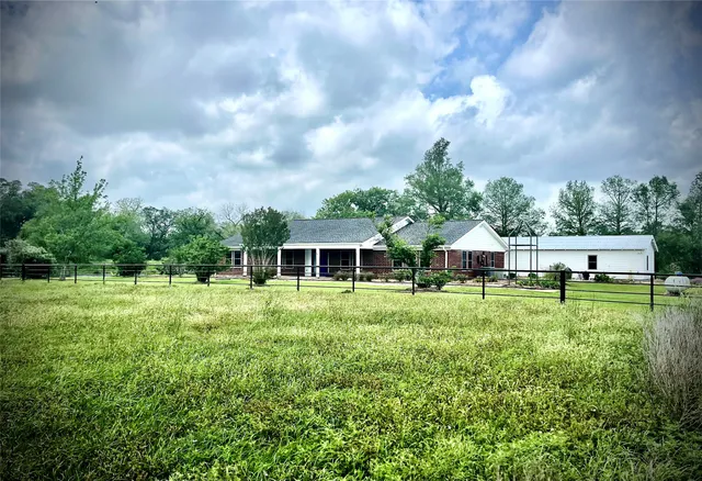 a view of an house with backyard space and garden