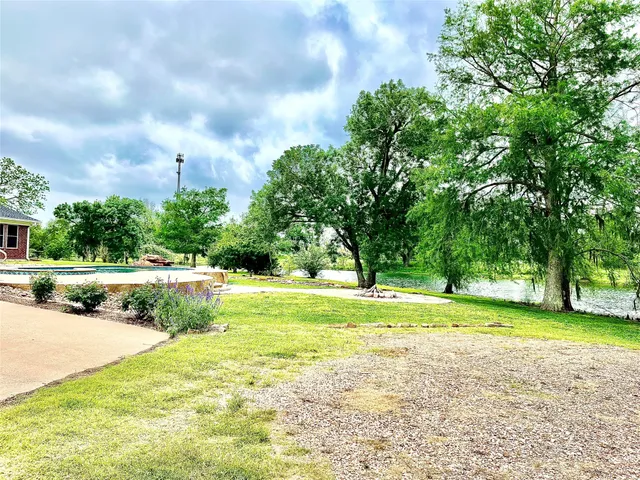 a view of a swimming pool and a yard