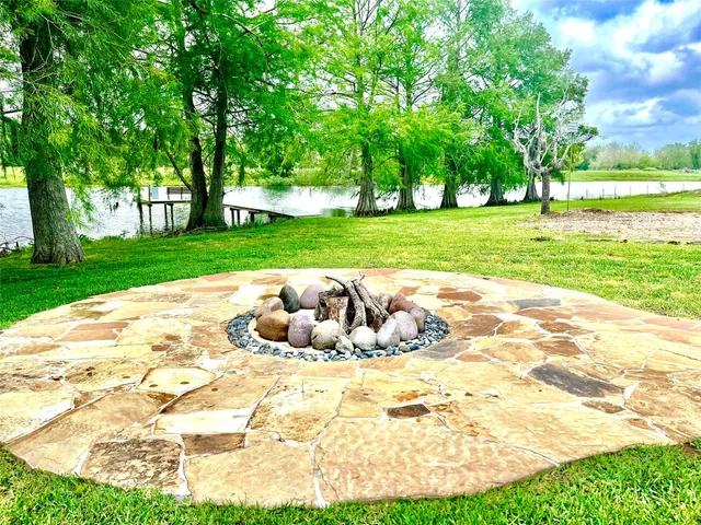 a backyard of a house with table and chairs