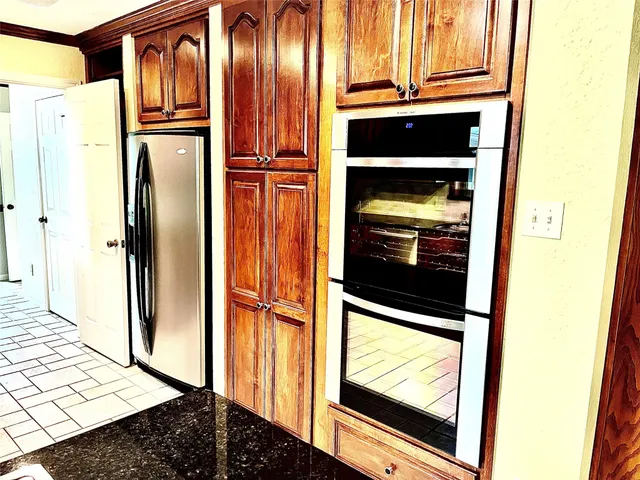 a view of kitchen with wooden floor washer and dryer