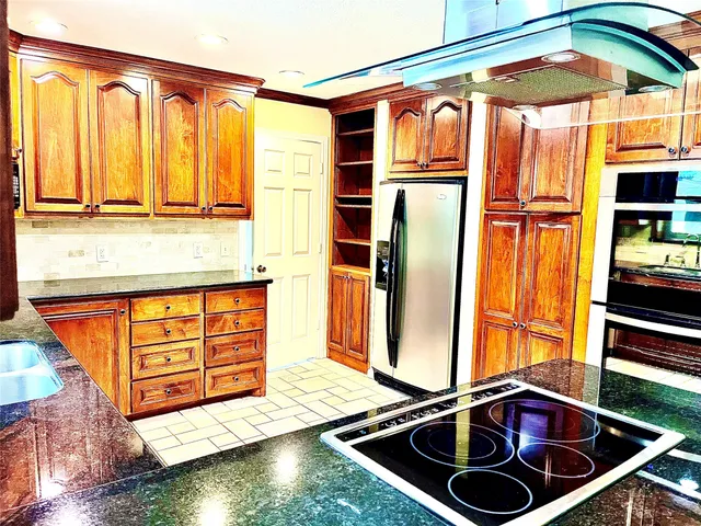 a kitchen with stainless steel appliances granite countertop a sink and a cabinets