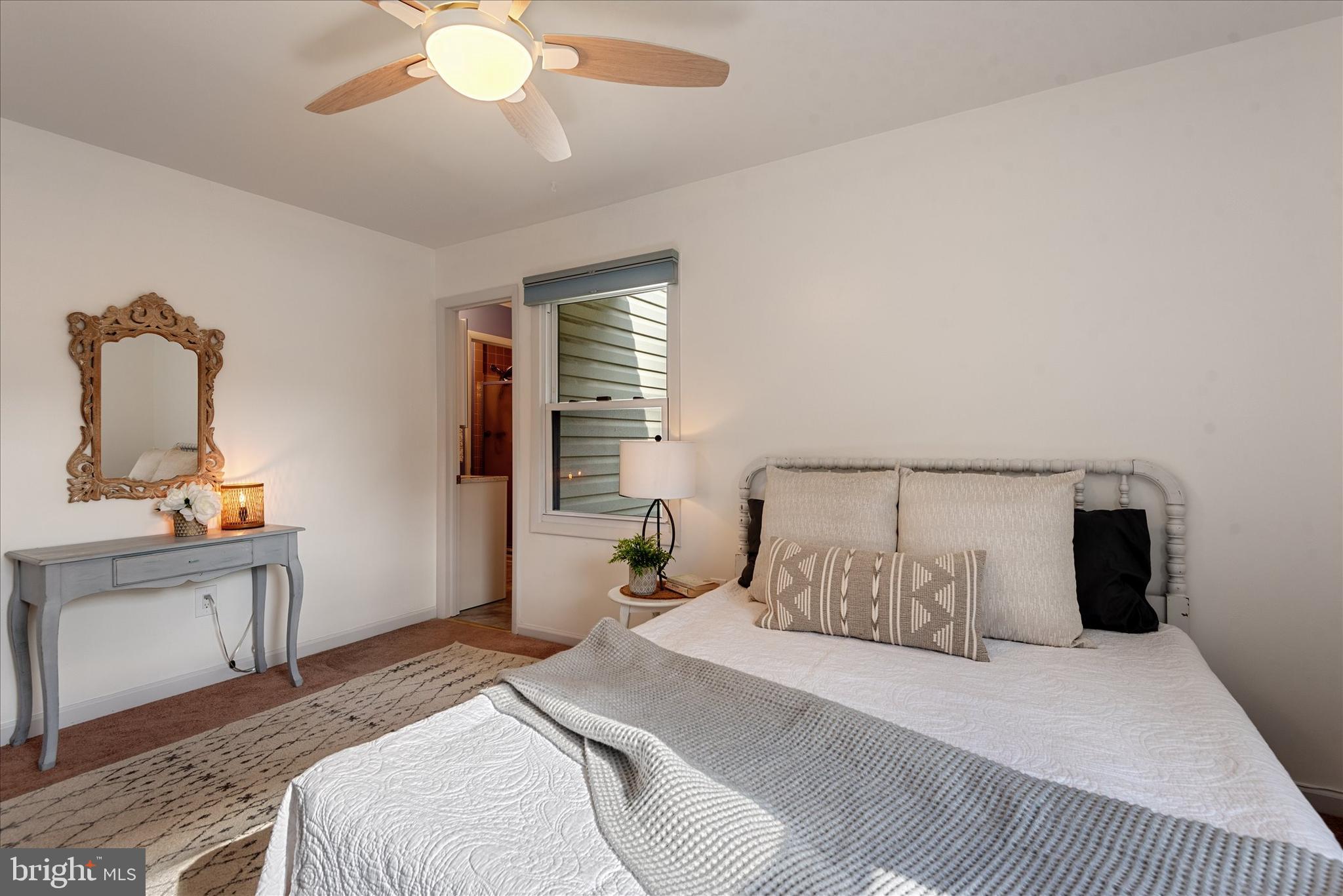7967 Citadel Drive Severn, MD 21144 - Photo 20 of 52 a bedroom with a large bed and a chandelier