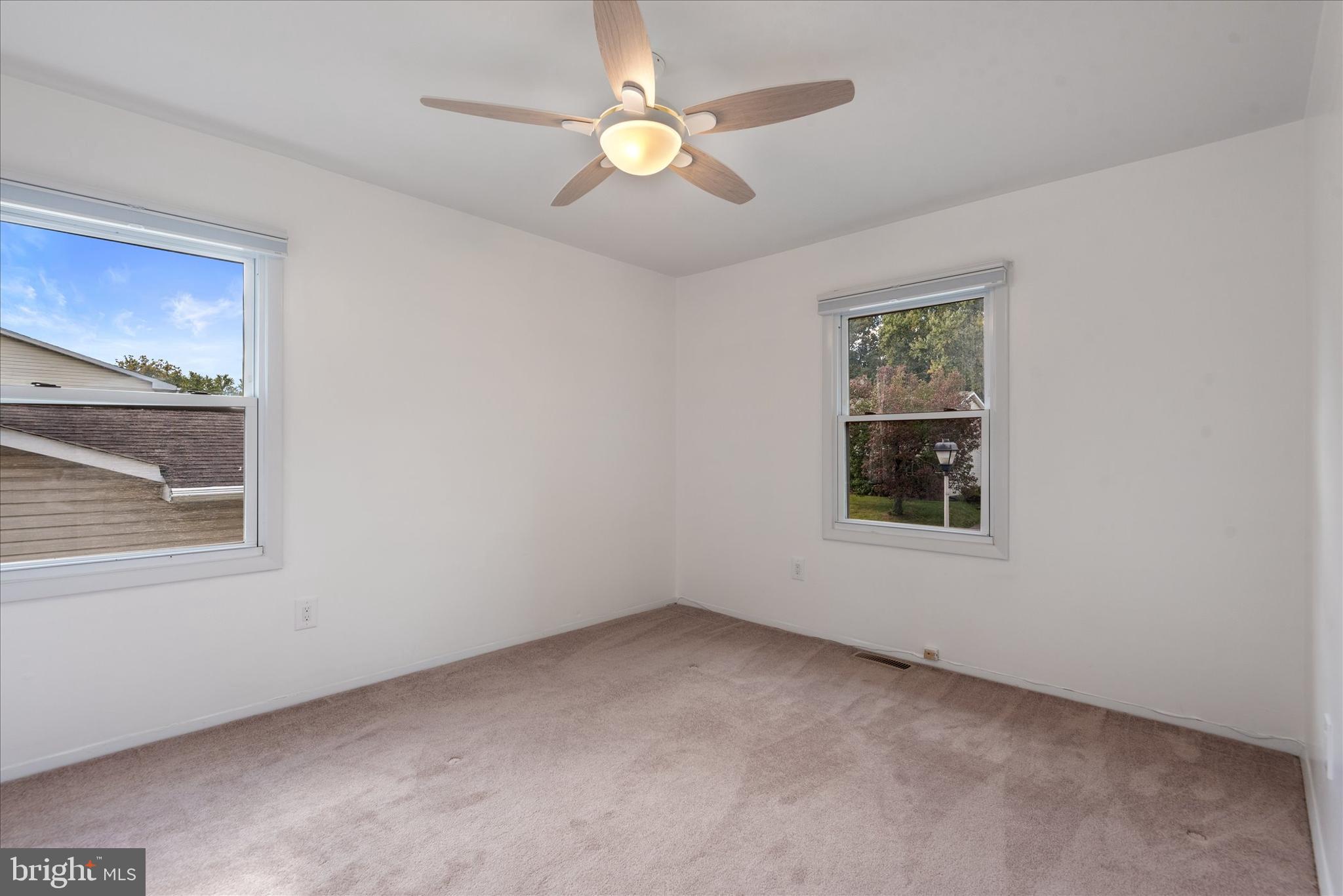 7967 Citadel Drive Severn, MD 21144 - Photo 23 of 52 an empty room with a window and a fan