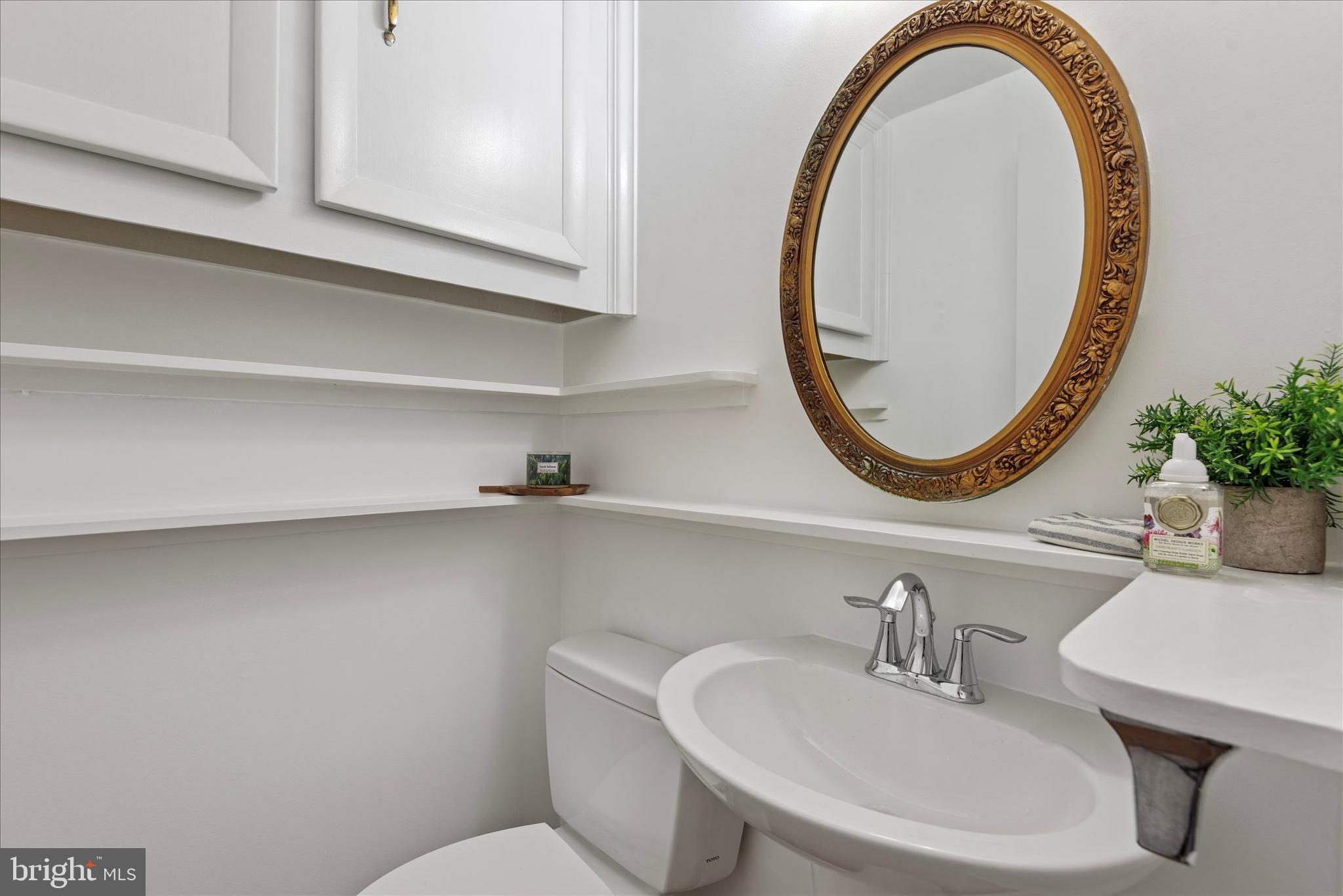 7967 Citadel Drive Severn, MD 21144 - Photo 33 of 52 a bathroom with a sink a mirror and a toilet