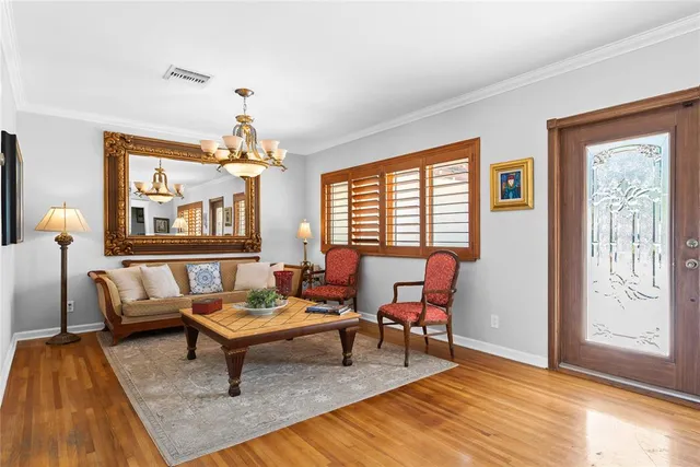 a living room with furniture and a chandelier