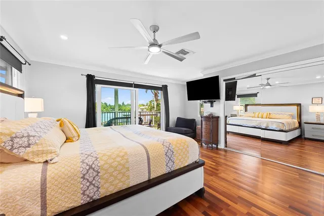 a bedroom with a bed window and a flat screen tv