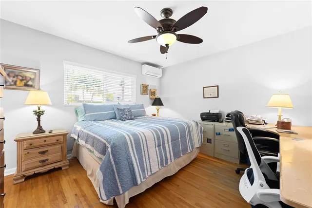 a bedroom with a bed and a desk