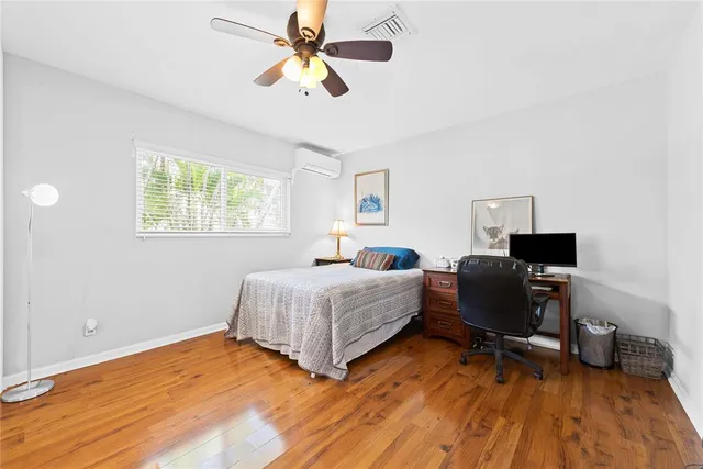 a bedroom with a bed and a desk