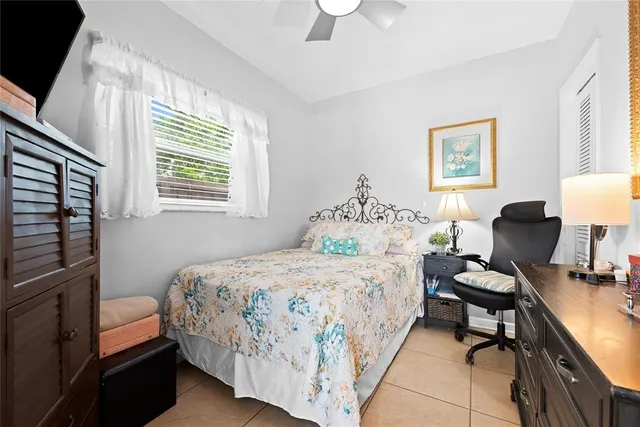 a bedroom with a bed wooden floor and a desk