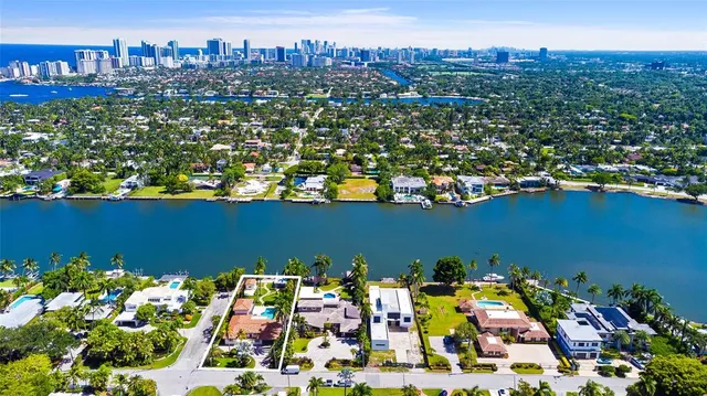 an aerial view of a houses with a lake view