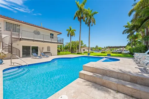 a living room with furniture a flat screen tv and a large window
