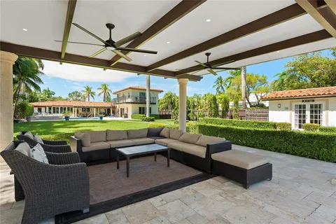 a kitchen with stainless steel appliances granite countertop a sink a stove cabinets counter space and a window