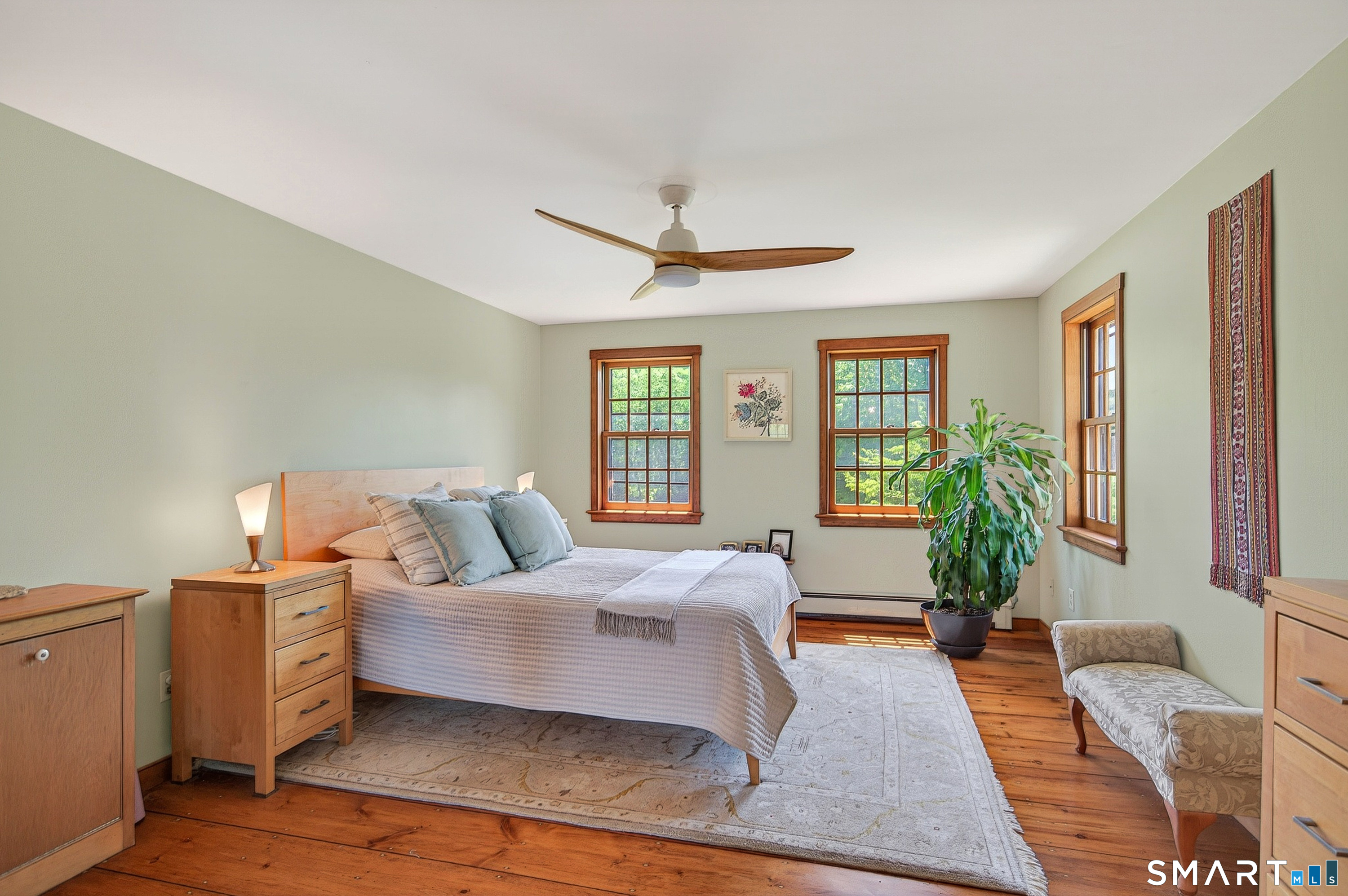 174 Huntingtown Road Newtown, CT 06470 - Photo 23 of 40 a bedroom with a large bed and wooden floor