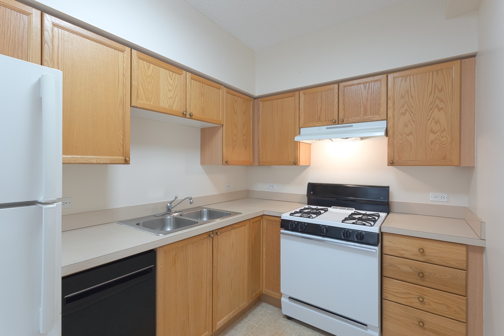 2000 Randi Drive, Unit 310 Aurora, IL 60504 - Photo 13 of 19 a kitchen with stainless steel appliances a sink stove and refrigerator